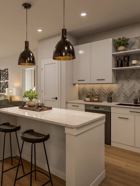 Modern kitchen with white cabinets, marble island, pendant lights, and open living area in the background.